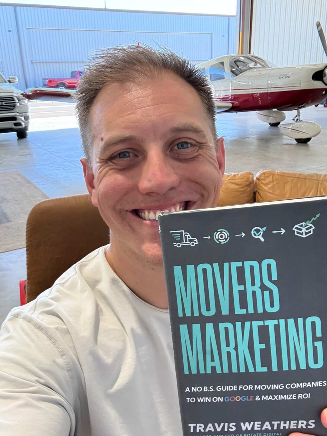 Travis with his book, Movers Marketing